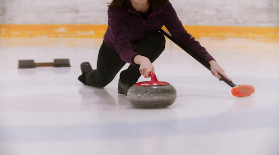 A girl plays curling.
